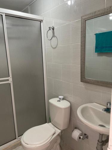 a bathroom with a toilet and a sink at Apartamento GUATAPE in Guatapé