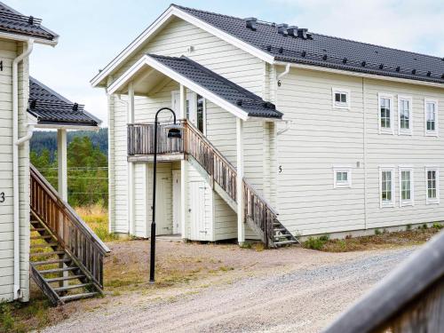 a large white building with a porch and stairs at 8 person holiday home in LOFSDALEN in Lofsdalen