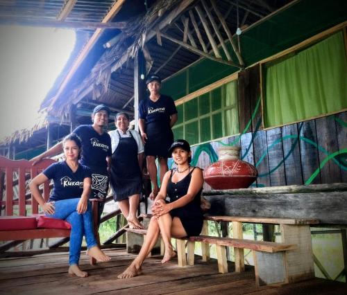 a group of people sitting in a hut at Casa Kukama Lodge in Iquitos