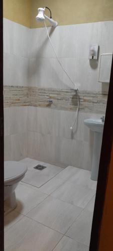 a bathroom with a shower and a toilet and a sink at Hospedaje San Miguel in Luque