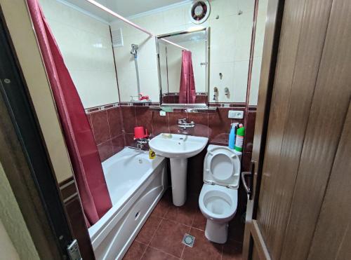 a bathroom with a sink and a toilet and a bath tub at MY APARTMENT IN CENTRAL PARK in Batumi