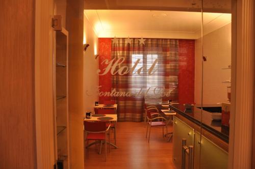 a kitchen with a table and chairs in a room at Hotel Fontana Del Re in Ariano Irpino