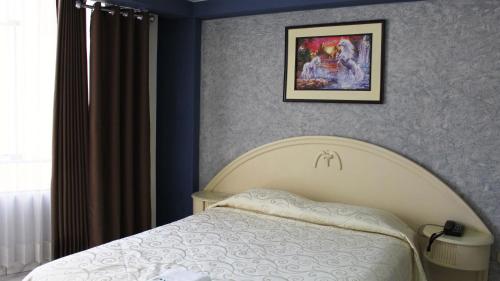 Hotel Mediterraneo Arequipa tesisinde bir odada yatak veya yataklar
