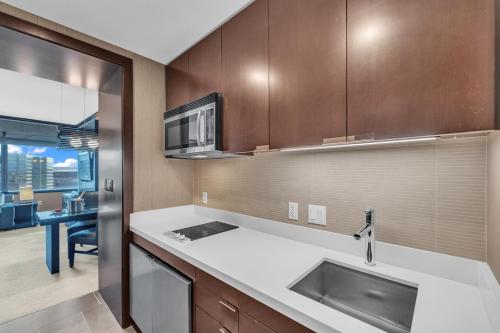 a kitchen with a sink and a microwave at VDARA Beautiful suite on 22nd FLR Free Valet parking in Las Vegas