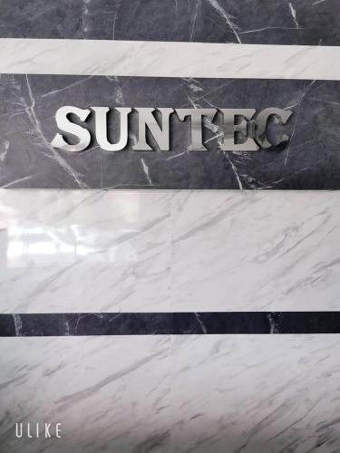 a sign that says sunbeams on a marble wall at SUNTEC HOTEL in Johor Bahru