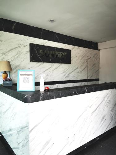 a counter in a hotel room with a sign on it at SUNTEC HOTEL in Johor Bahru