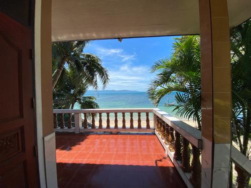 a view of the ocean from the balcony of a house at Rainbow Bungalow Haadrin Koh Phangan in Haad Rin