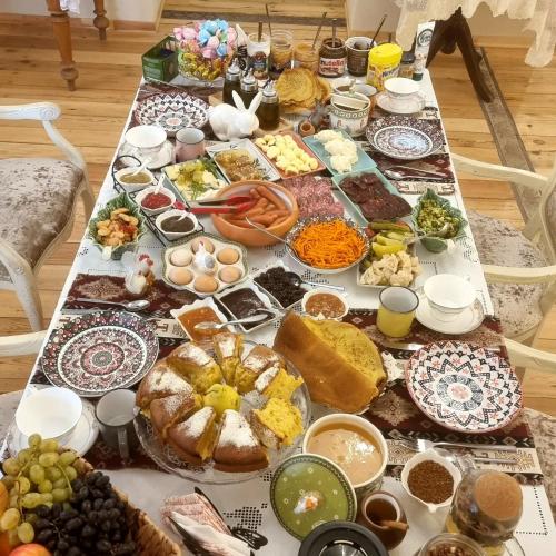 a table with many different types of food on it at Deghceni clubhouse in Dilijan