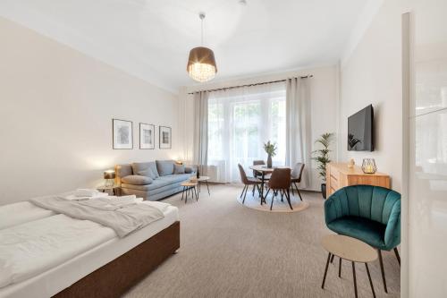 a bedroom with a bed and a living room at Rezidence Villa Gloria in Mariánské Lázně