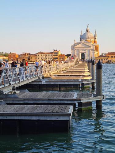 a bridge over a body of water with people on it at Ca' Nova - Burano in Burano