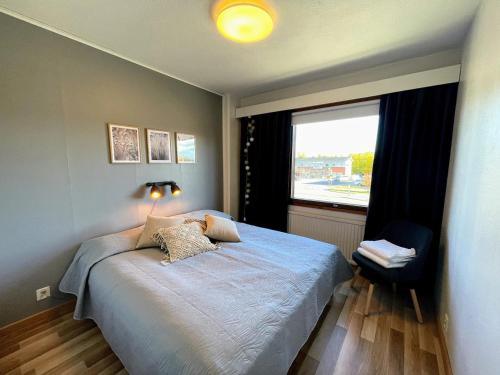 a bedroom with a bed and a large window at Pine Sky in Ivalo