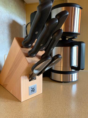 a knife block with knives in it on a counter at Ferienhaus am Burgsee in Ladis