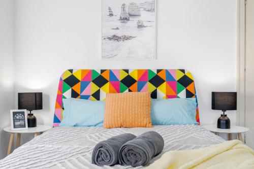 a bedroom with a bed with a colorful headboard at Burwood Newly Renovated 2 Bedroom Apartment in Sydney
