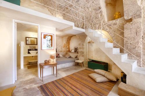 a room with a staircase and a living room at Dammusi Beneventano in Scicli