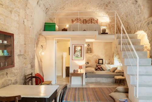 a room with a staircase and a bed in a room at Dammusi Beneventano in Scicli