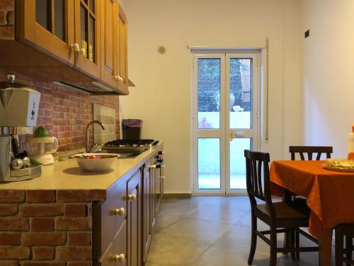 a kitchen with a counter and a table with a dining room at La Casa di Antonella in Agrigento