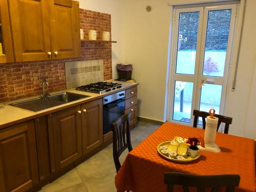 a kitchen with a table and a stove top oven at La Casa di Antonella in Agrigento