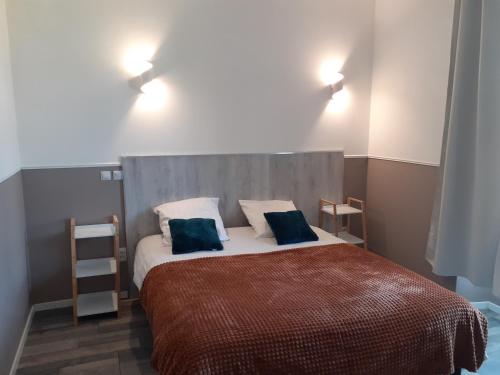 - une chambre avec un grand lit et 2 oreillers bleus dans l'établissement CHAMBRES D'HOTES DANS DOMAINE DE CHARME A EPERNAY, à Mardeuil