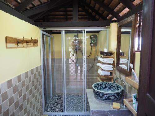 a shower with a glass door in a bathroom at Chiangmai Lanna in San Kamphaeng