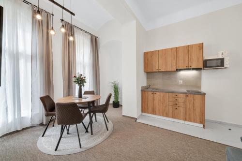 a kitchen and dining room with a table and chairs at Rezidence Villa Gloria in Mariánské Lázně