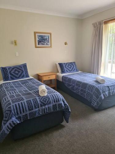 a hotel room with two beds and a window at DELANY VILLAS BRIGHT - Spa luxury on Delany Avenue in Bright