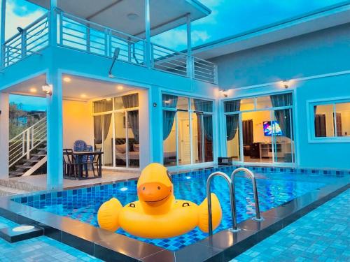 a large inflatable rubber duck in a swimming pool at Vanilla Sky @Khao Yai in Ban Bung Toei