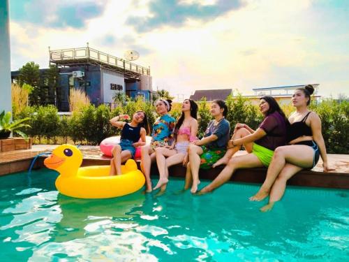 a group of people sitting on a raft in a pool at Vanilla Sky @Khao Yai in Ban Bung Toei