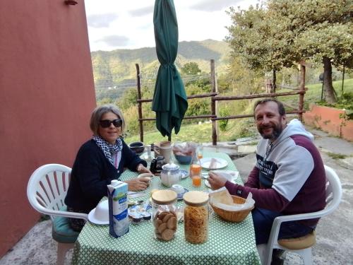 a man and a woman sitting at a table at ANITA B&B in Uscio