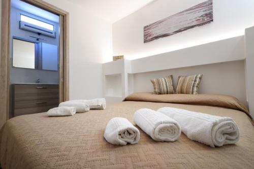 Un dormitorio con dos camas con toallas y un espejo. en Tenuta Ferilli, en Salve