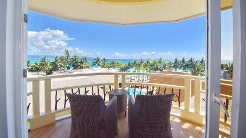 a balcony with chairs and a view of the ocean at Ambassador In Paradise in Boracay