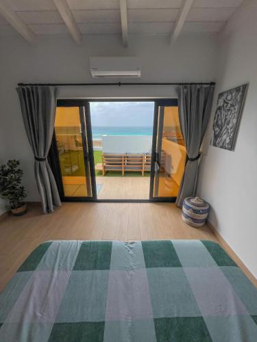 a bedroom with a bed and a view of the ocean at New Rooftop Gem with stunning Oceanview in Santa Maria