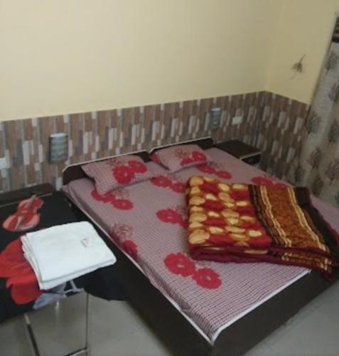 a bed with a blanket on top of it at Panna Tiger Home Stay in Khajurāho