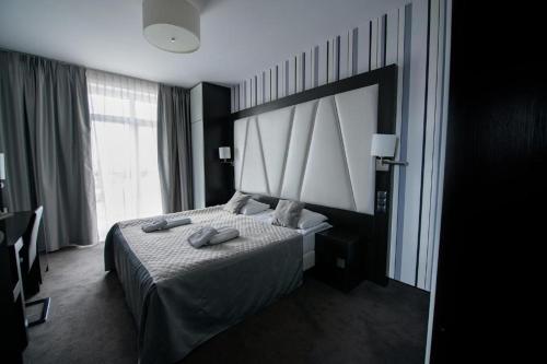 a hotel room with a bed and a large window at Hotel Grafit in Kielce