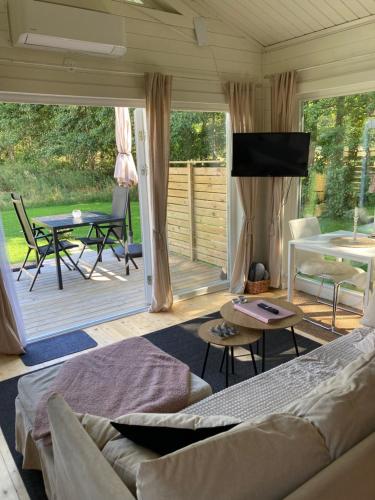 a living room with a couch and a patio at Karupsvägen 47-23, Blentarp in Blentarp
