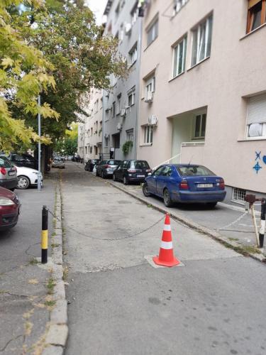 a orange traffic cone sitting in the middle of a street at Kopernik - parking available in Belgrade