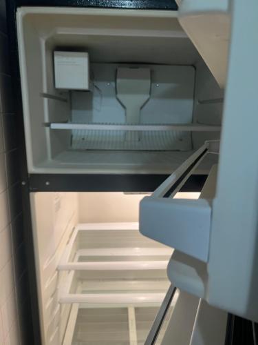 an empty refrigerator with its door open with the door open at Lovely three Bedroom Apartment near Jersey city and Newyork in Linden