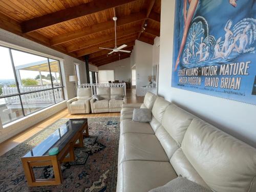 a living room with a couch and a table at Dromana Panoramic Views in Dromana