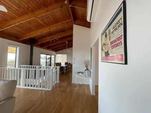 a living room with a movie poster on the wall at Dromana Panoramic Views in Dromana