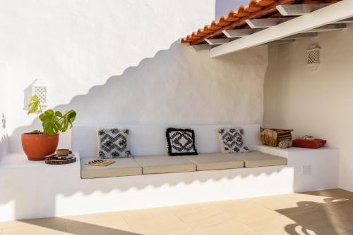 a couch in a white room with a staircase at Sea'Ya Thoughtful Stays - Villas in Cascais