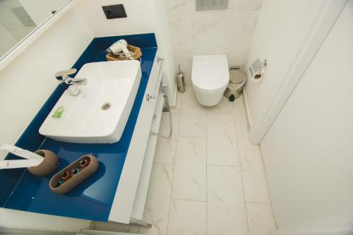a bathroom with a sink and a toilet at Batumi River Source in Batumi