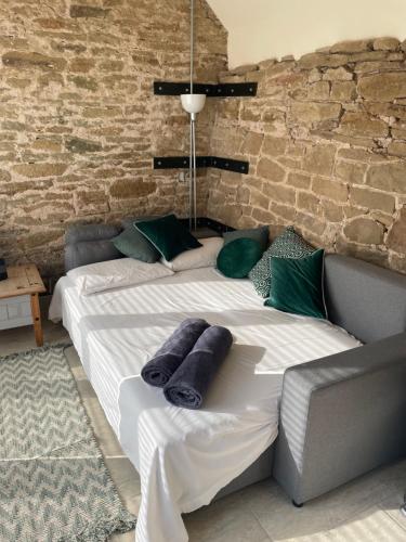 two beds in a room with a brick wall at Beautiful countryside Byre conversion in Shrewsbury