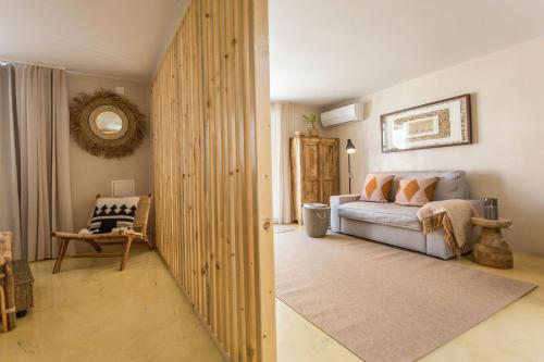 a living room with a couch and a chair at SeaYa Villas in Cascais