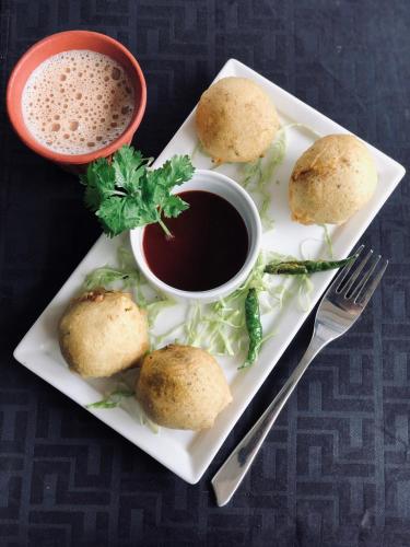 a plate of food with biscuits and a cup of coffee at GP Hotels and Resorts in Nashik
