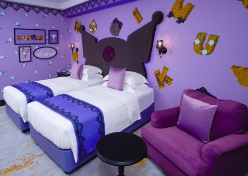 a purple bedroom with two beds and a couch at Grand Hi Lai Hotel in Kaohsiung