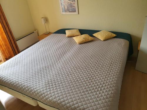 a bed with two pillows on it in a bedroom at Private Apartment Skudehaven in Rudkøbing