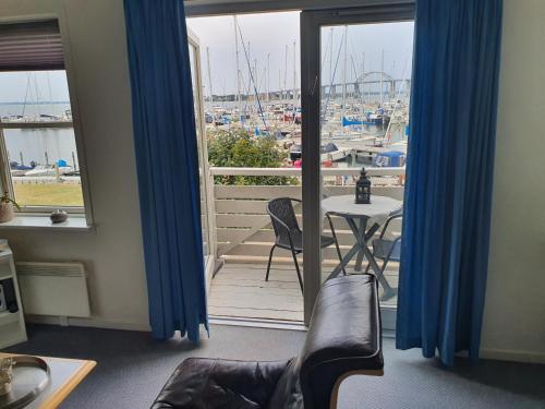 a room with a balcony with a view of a marina at Private Apartment Skudehaven in Rudkøbing