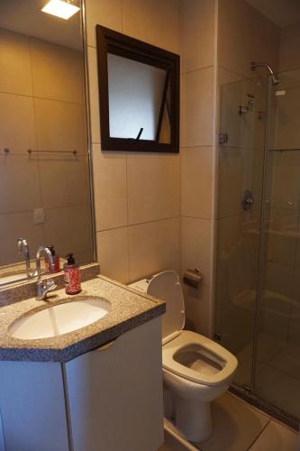 a bathroom with a toilet and a sink and a shower at Cumbuco - VGSun Apartment 402 in Cumbuco