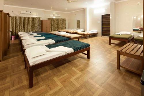a row of mattresses in a room with wooden floors at GP Hotels and Resorts in Nashik
