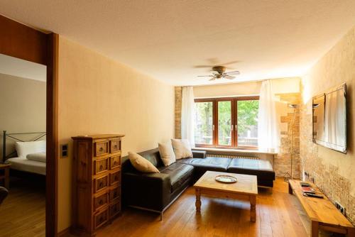 ein Wohnzimmer mit einem Sofa und einem Tisch in der Unterkunft stylish apartment Old Town free parking in Heidelberg