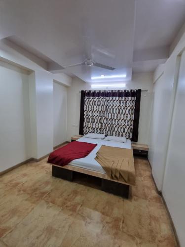 a bedroom with a bed in a room at Sai Anand in Nashik